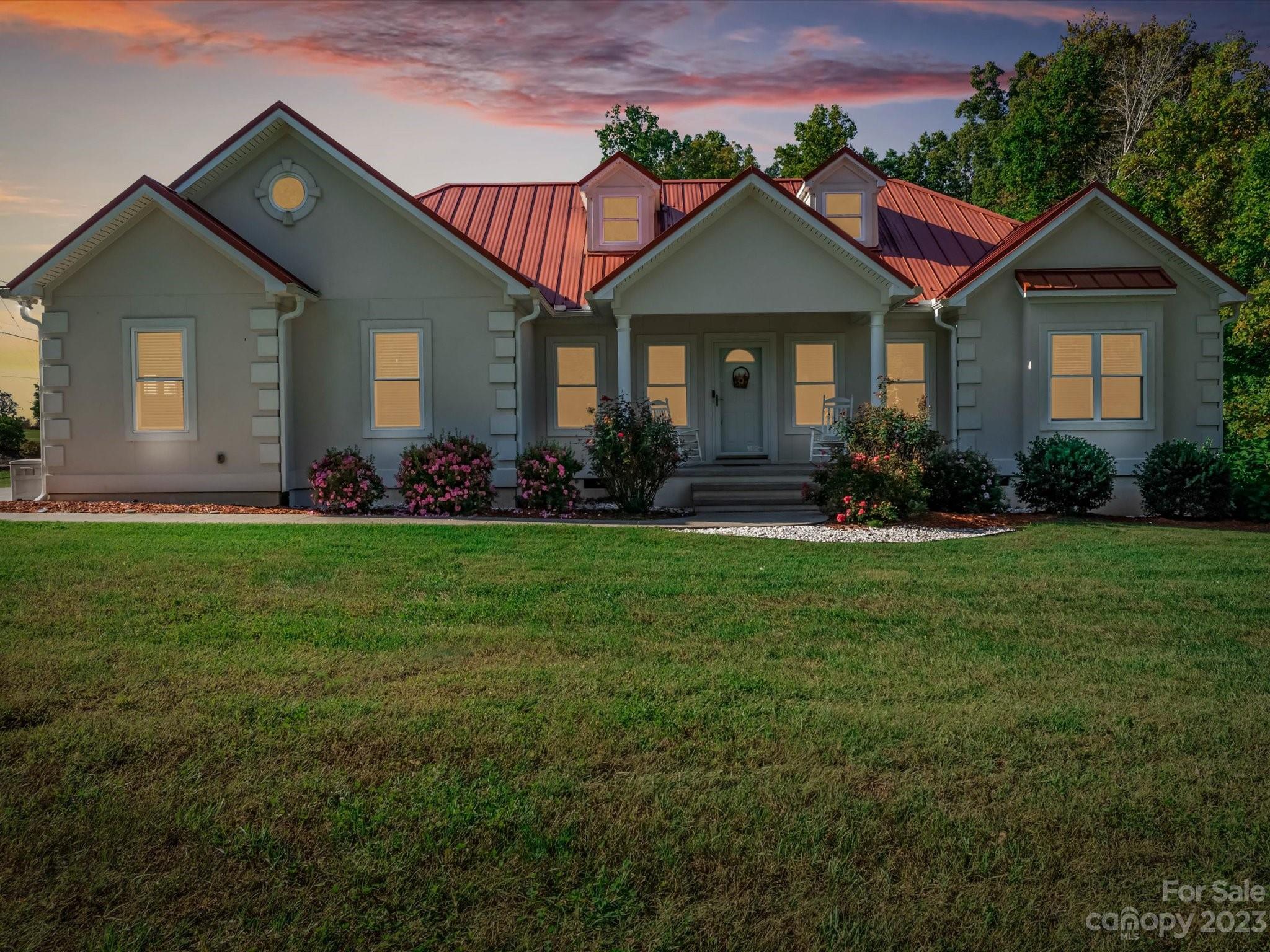 125 Boulder Ridge Drive State Road, NC 28676 - Photo 39 of 39 a front view of a house with a garden and plants