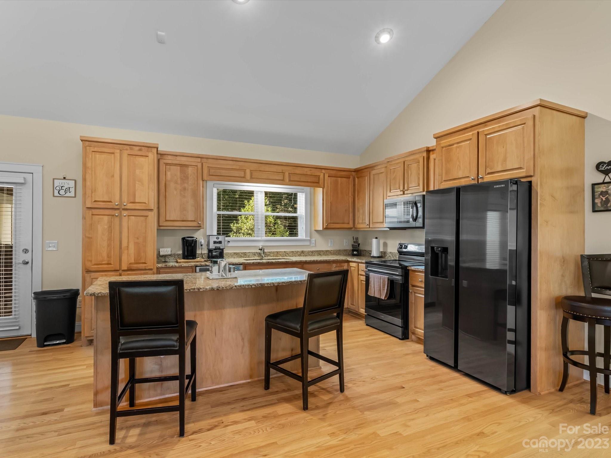125 Boulder Ridge Drive State Road, NC 28676 - Photo 6 of 39 a kitchen with a refrigerator a table and chairs in it