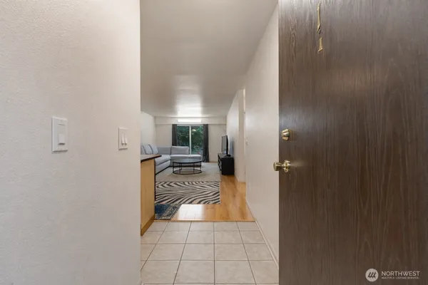 a kitchen with a dining table chairs and refrigerator