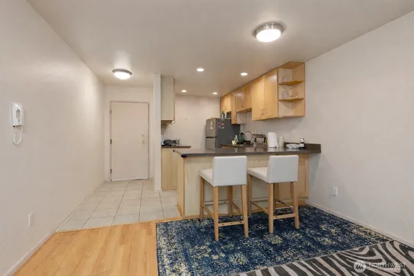 a kitchen with stainless steel appliances a sink a stove a refrigerator cabinets and a counter top space
