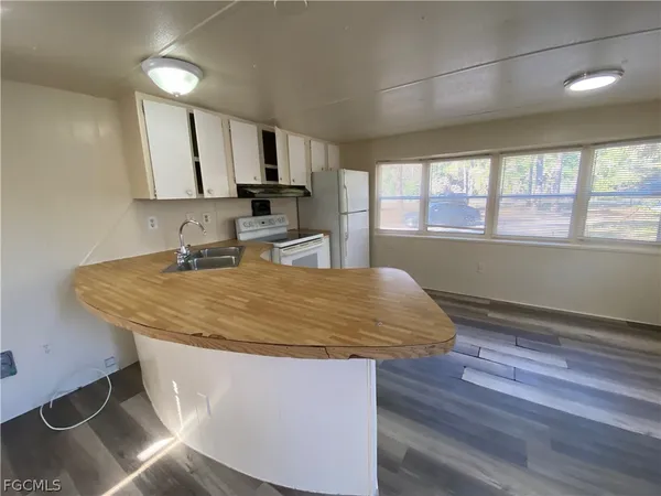 a room with wooden floor and window