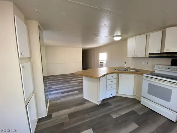 a kitchen with white cabinets and white appliances