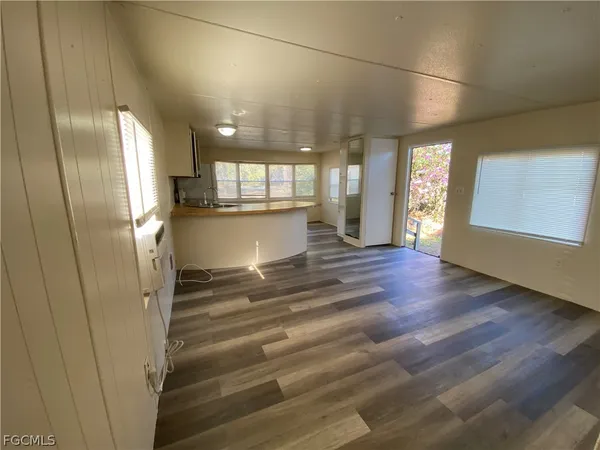 a view of a kitchen with a refrigerator and window