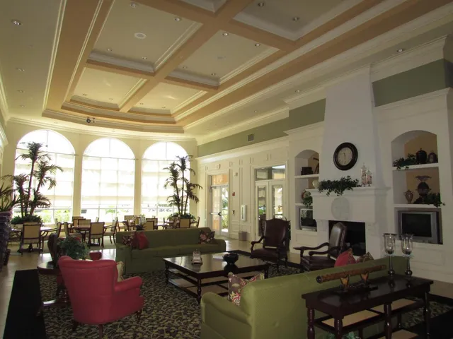 a living room with fireplace furniture and a large window