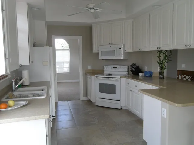 a kitchen with cabinets appliances and a sink