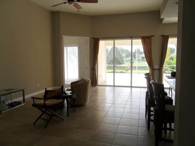 a living room with furniture and a floor to ceiling window