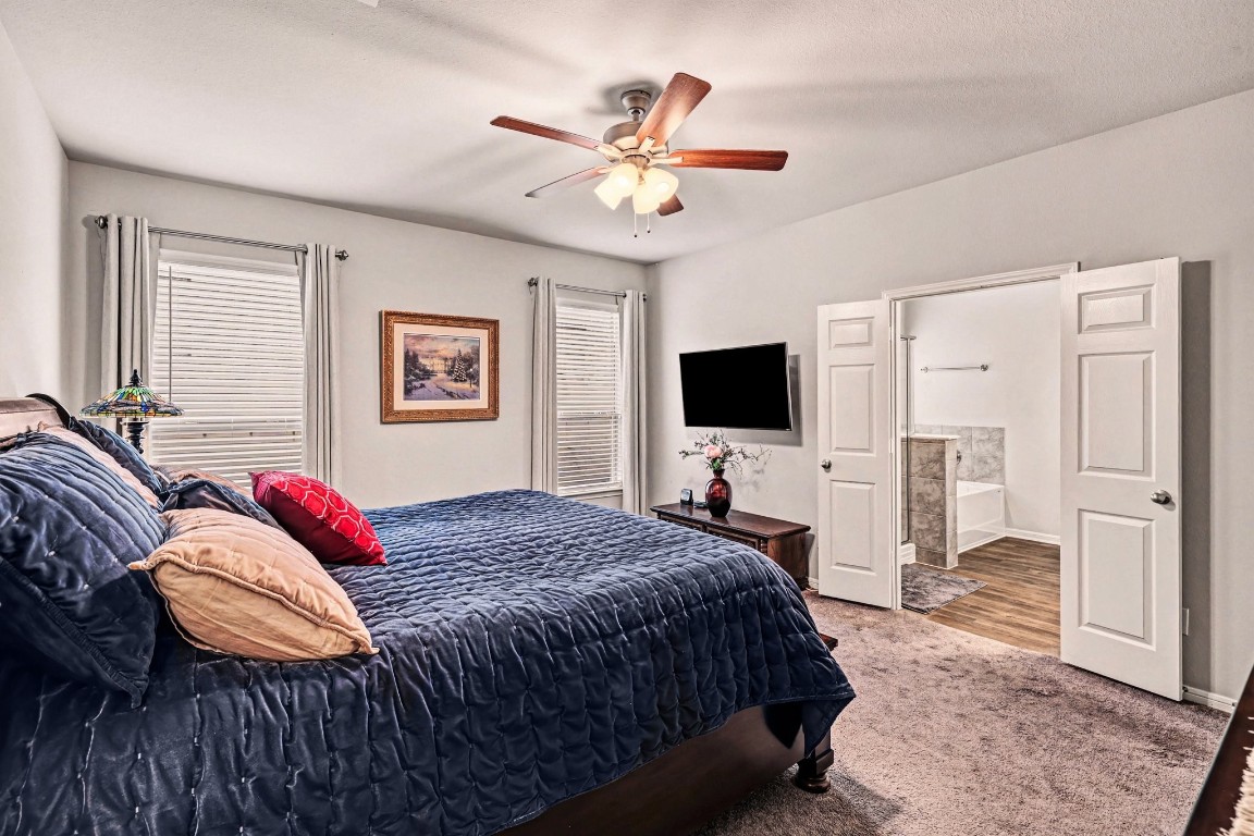 320 Red Maple Lane Conroe, TX 77304 - Photo 12 of 27 a bedroom with a bed and a flat screen tv