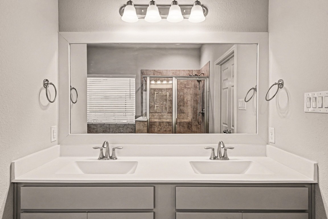 320 Red Maple Lane Conroe, TX 77304 - Photo 15 of 27 a bathroom with a sink and a mirror