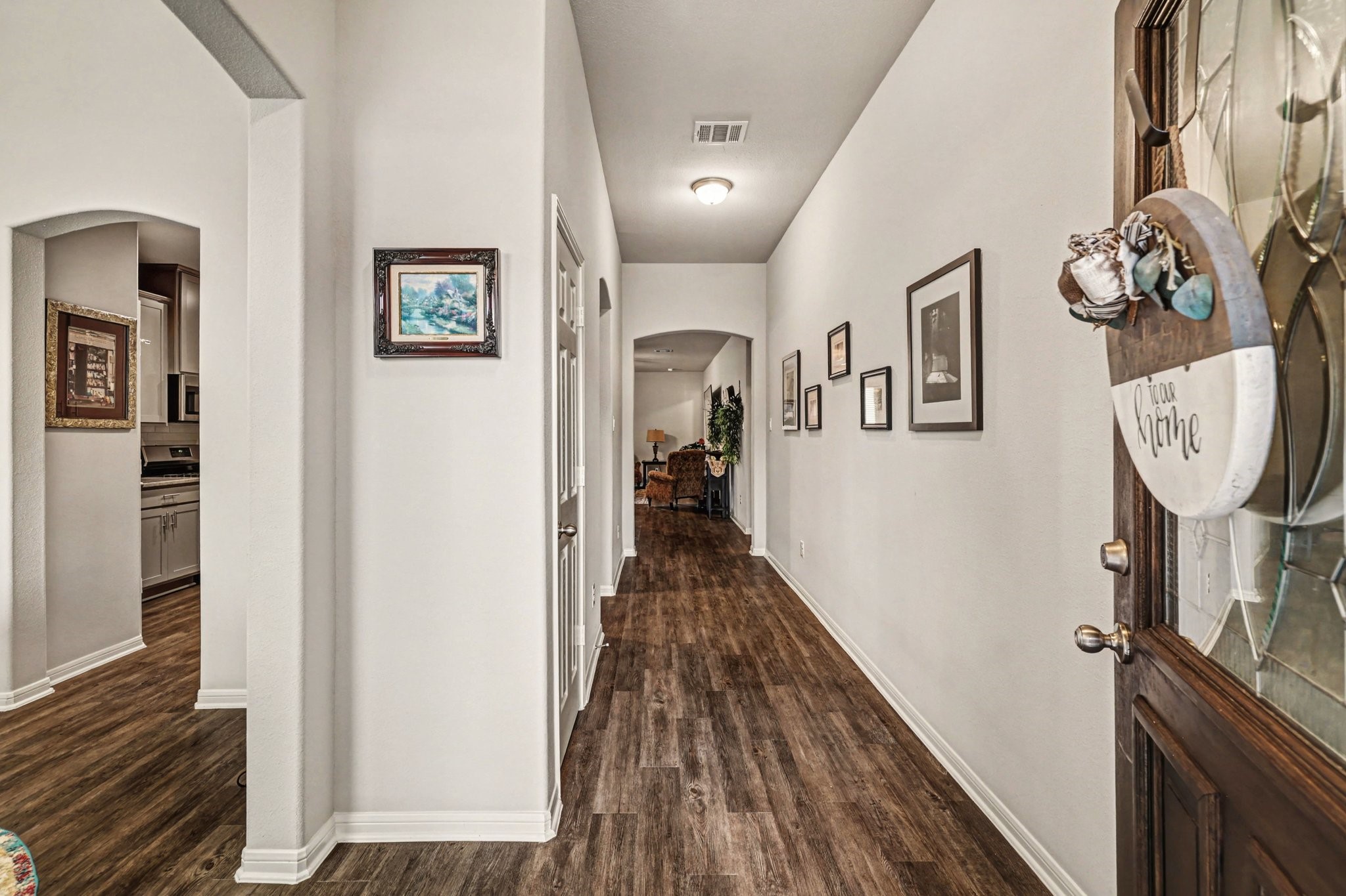 320 Red Maple Lane Conroe, TX 77304 - Photo 5 of 27 a view of a hallway with wooden floor and staircase