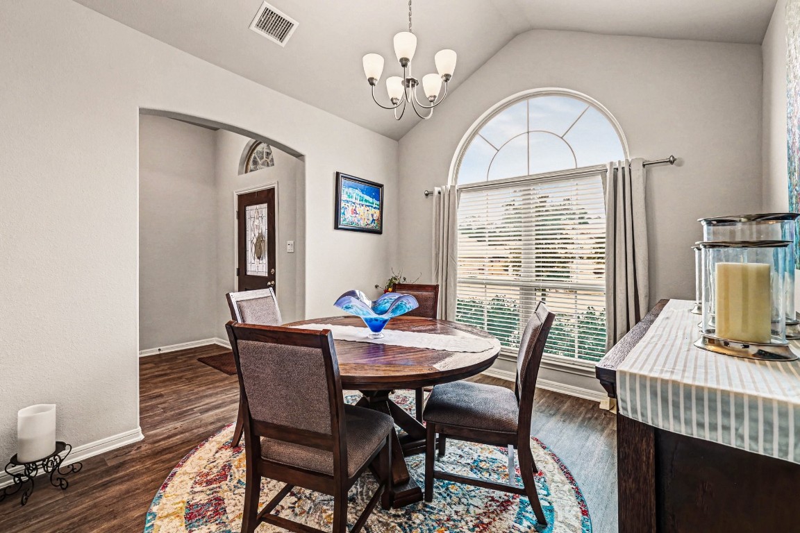320 Red Maple Lane Conroe, TX 77304 - Photo 6 of 27 a view of a dining room with furniture a chandelier and wooden floor