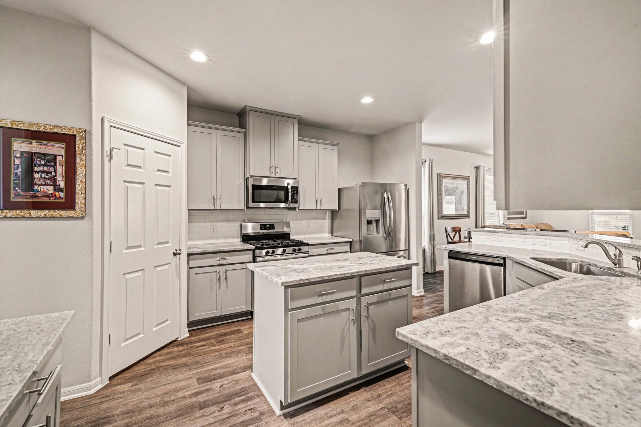 320 Red Maple Lane Conroe, TX 77304 - Photo 8 of 27 a kitchen with white cabinets and stainless steel appliances