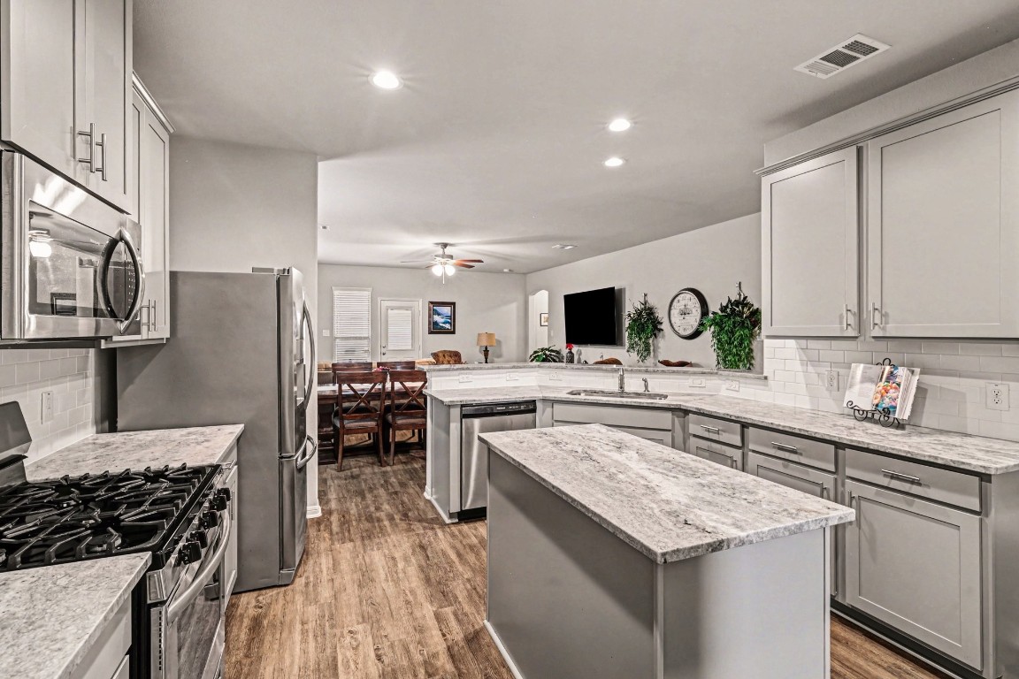 320 Red Maple Lane Conroe, TX 77304 - Photo 9 of 27 a kitchen with a sink stove and refrigerator