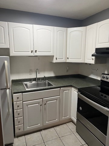 110 Boston Post Road East, Unit 4 Marlborough, MA 01752 - Photo 1 of 13 a kitchen with white cabinets and appliances