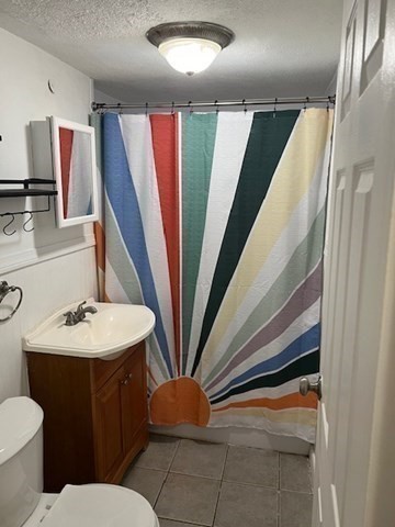 110 Boston Post Road East, Unit 4 Marlborough, MA 01752 - Photo 12 of 13 a bathroom with a sink and a mirror