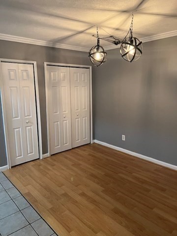 110 Boston Post Road East, Unit 4 Marlborough, MA 01752 - Photo 3 of 13 a view of a room with wooden floor and white walls