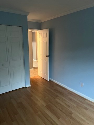 110 Boston Post Road East, Unit 4 Marlborough, MA 01752 - Photo 7 of 13 an empty room with wooden floor and windows