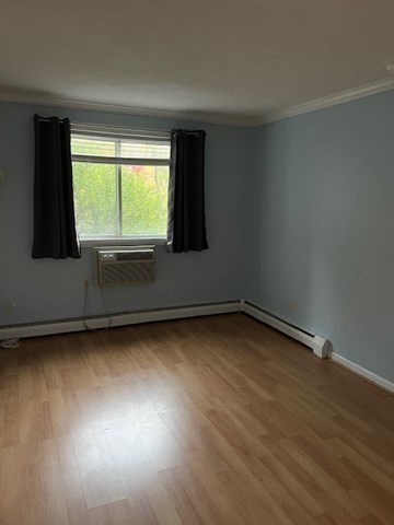 110 Boston Post Road East, Unit 4 Marlborough, MA 01752 - Photo 8 of 13 a view of an empty room with wooden floor and a window