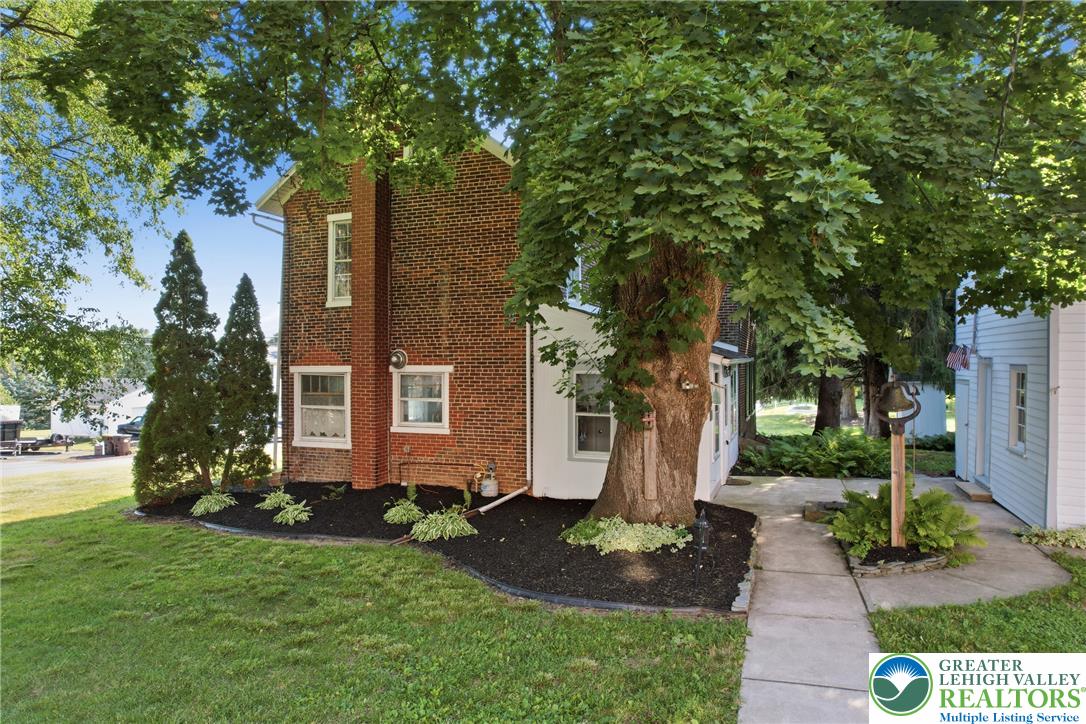 4682 Steuben Road Bethlehem, PA 18020 - Photo 79 of 79 Mature trees and neat landscaping frame this classic brick and white-sided residence.