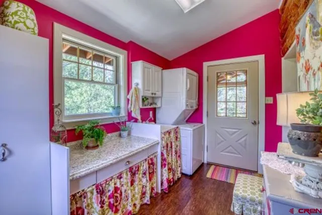 a bed sitting in a spacious bedroom next to a window