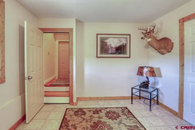 a bedroom with bed and wooden floor