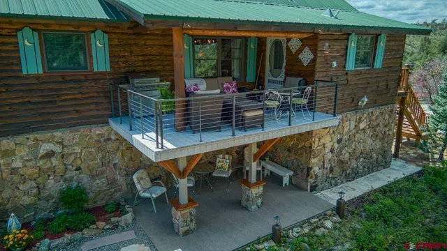a view of a balcony with furniture and a fire pit
