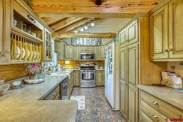 a kitchen with lots of counter top space and stainless steel appliances