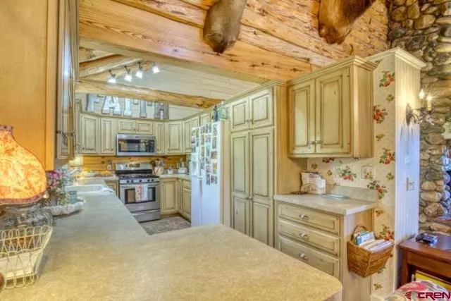a kitchen with refrigerator and cabinets