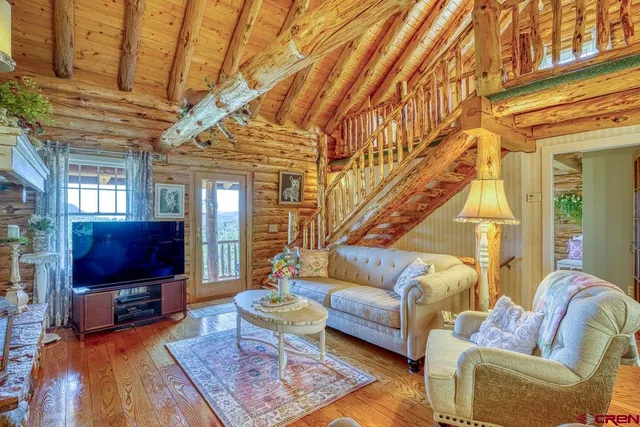 a living room with furniture a rug and a flat screen tv