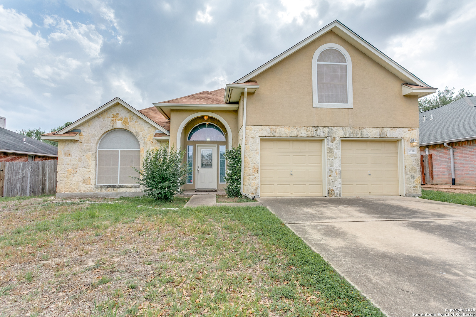 a front view of a house with a yard and garage