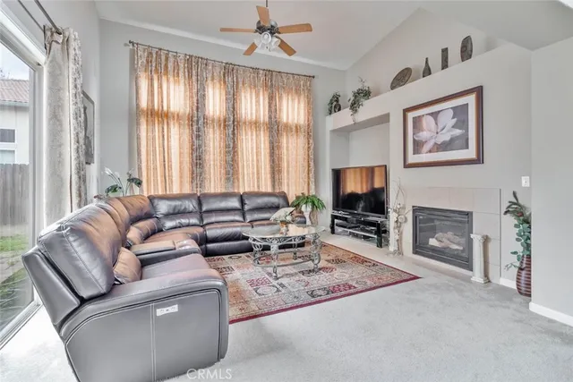 a living room with furniture a fireplace and a flat screen tv