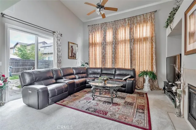 a living room with furniture a large window and a flat screen tv