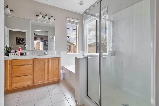 a bathroom with a granite countertop sink a mirror and shower