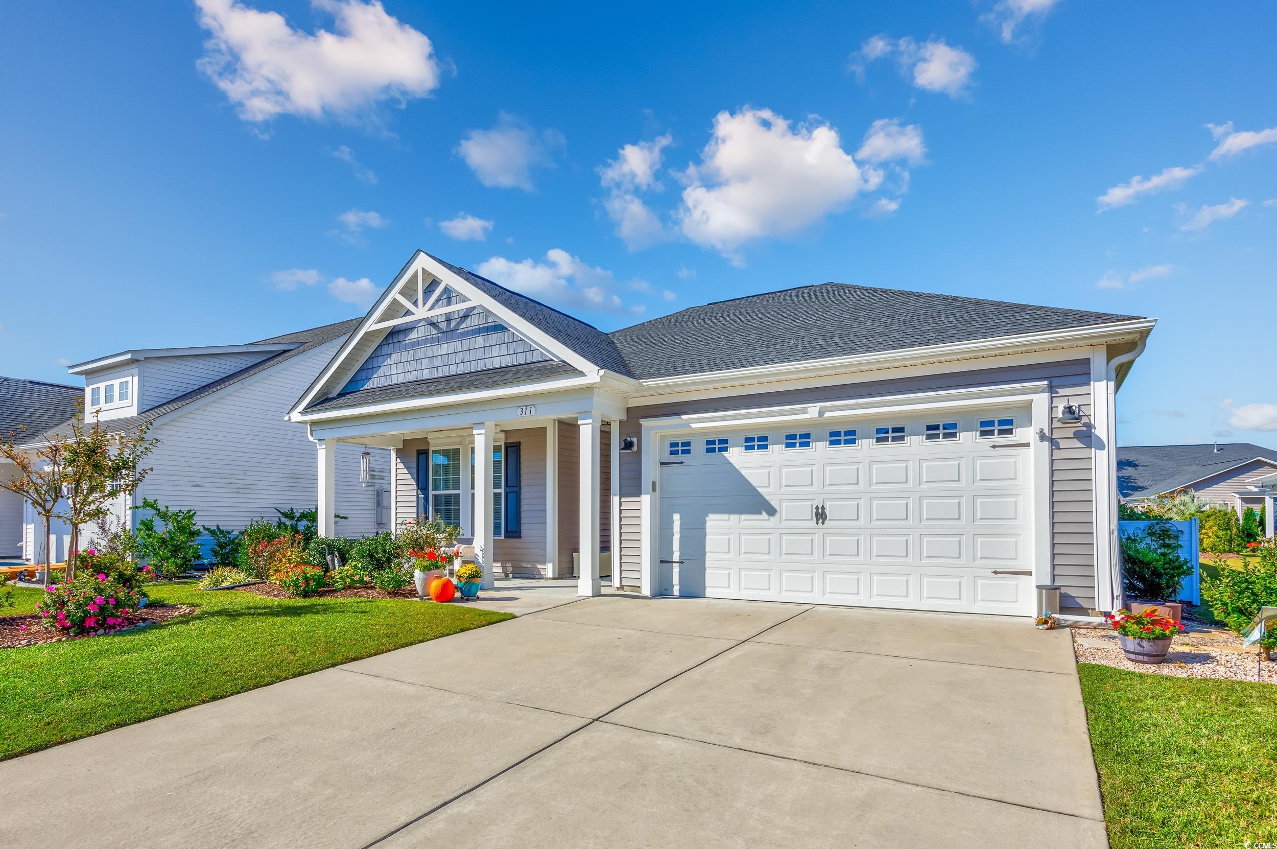 311 Switchgrass Loop Little River, SC 29566 - Photo 1 of 38 View of front facade featuring covered porch, a ga