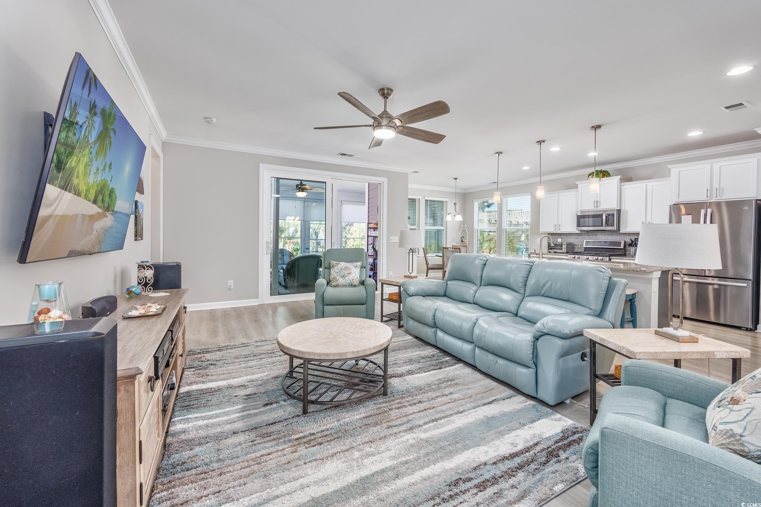311 Switchgrass Loop Little River, SC 29566 - Photo 11 of 38 Living room featuring ornamental molding, sink, li