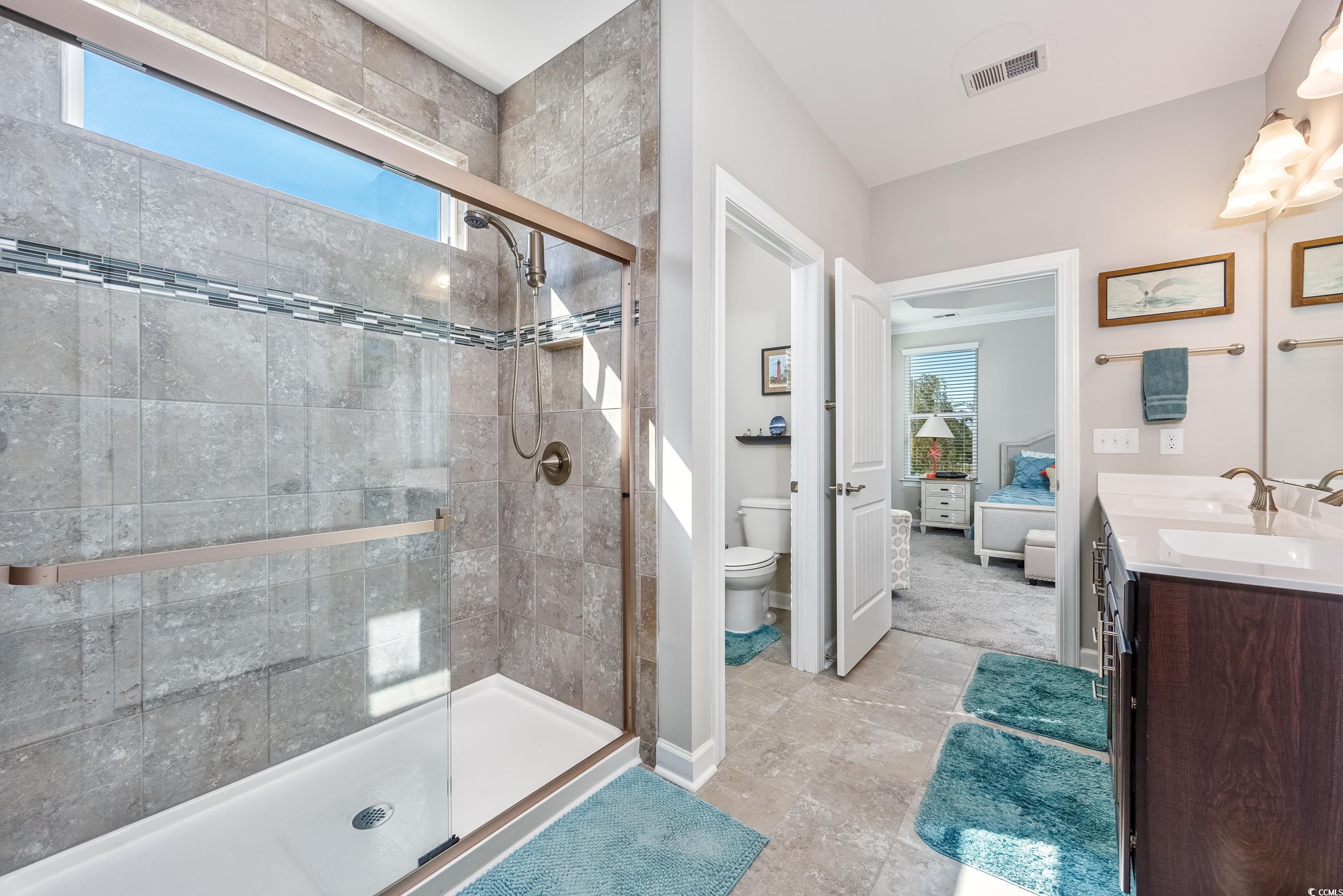 311 Switchgrass Loop Little River, SC 29566 - Photo 18 of 38 Bathroom featuring toilet, a shower with door, van
