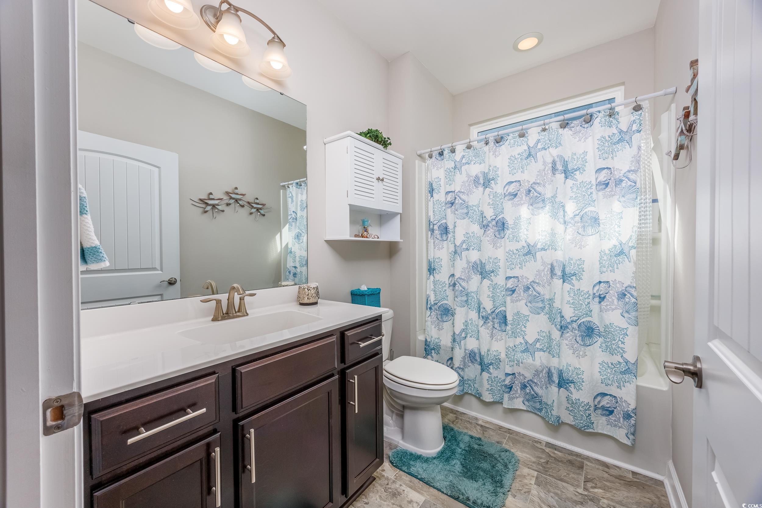 311 Switchgrass Loop Little River, SC 29566 - Photo 22 of 38 Full bathroom featuring vanity, toilet, and shower