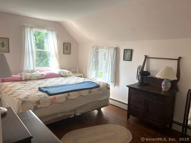a bedroom with a bed and window