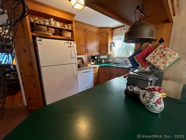 a kitchen with furniture a refrigerator and a stove