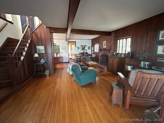 a living room with furniture fireplace and wooden floor