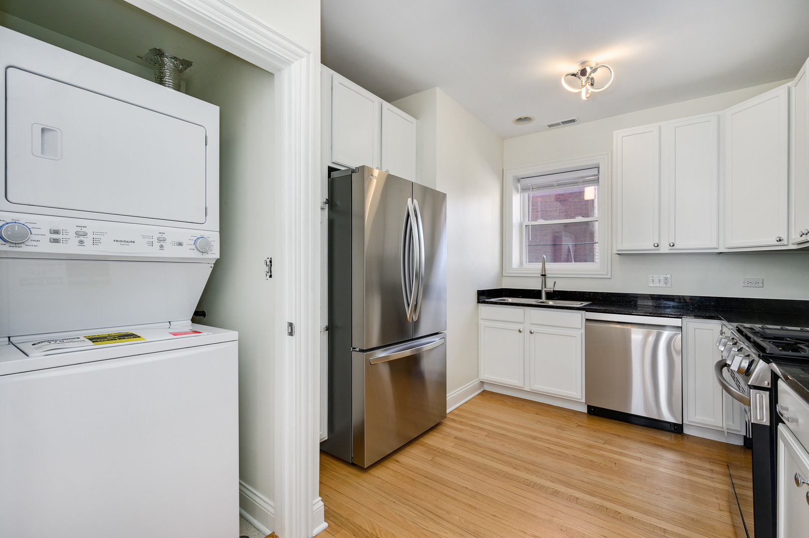 1544 West Sherwin Avenue, Unit 2N Chicago, IL 60626 - Photo 8 of 19 a kitchen with a refrigerator sink and microwave
