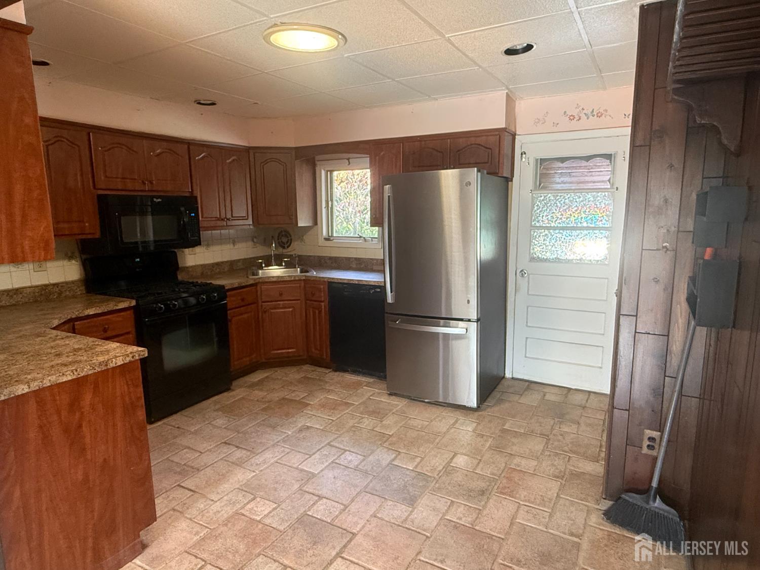 42 Boulevard East Old Bridge, NJ 07735 - Photo 3 of 14 a kitchen with stainless steel appliances granite countertop a refrigerator a stove and a sink