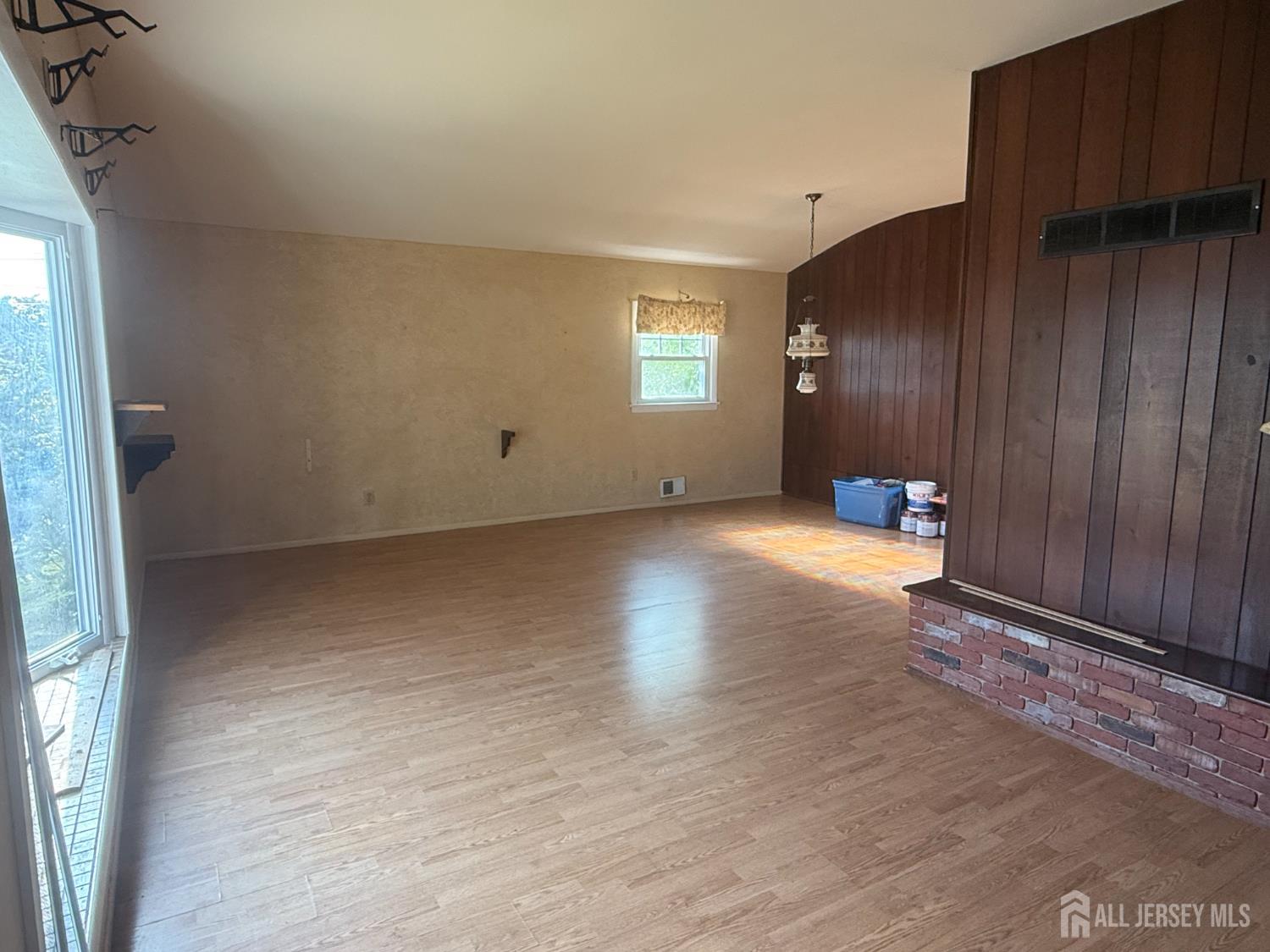 42 Boulevard East Old Bridge, NJ 07735 - Photo 4 of 14 a view of an empty room with wooden floor and a window