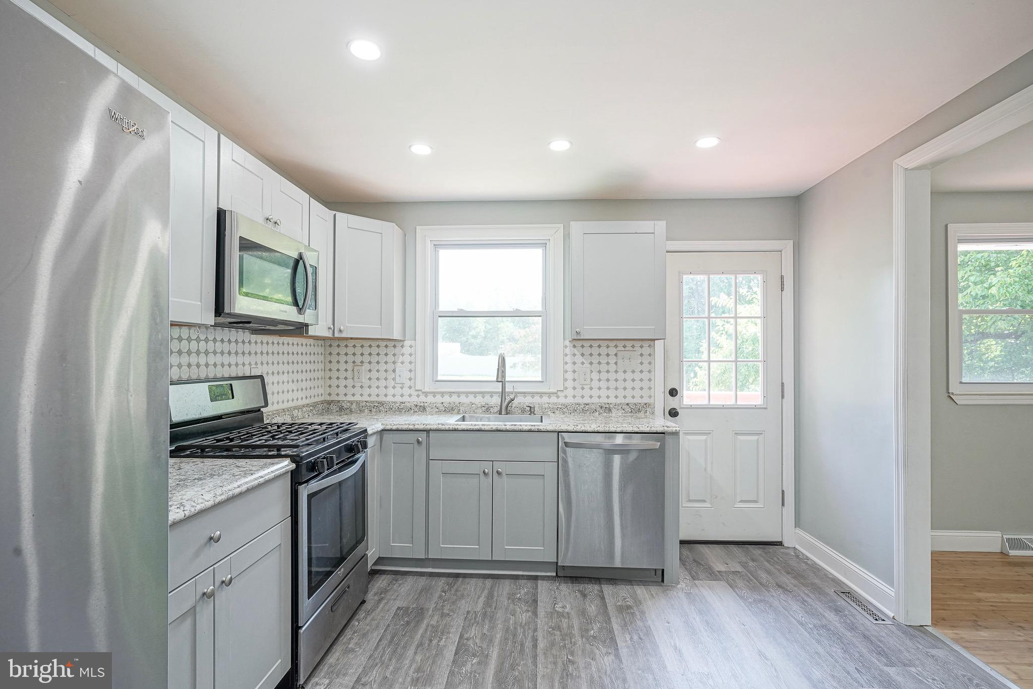 232 Egg Harbor Road Sewell, NJ 08080 - Photo 13 of 36 a kitchen with a sink cabinets wooden floor and stainless steel appliances