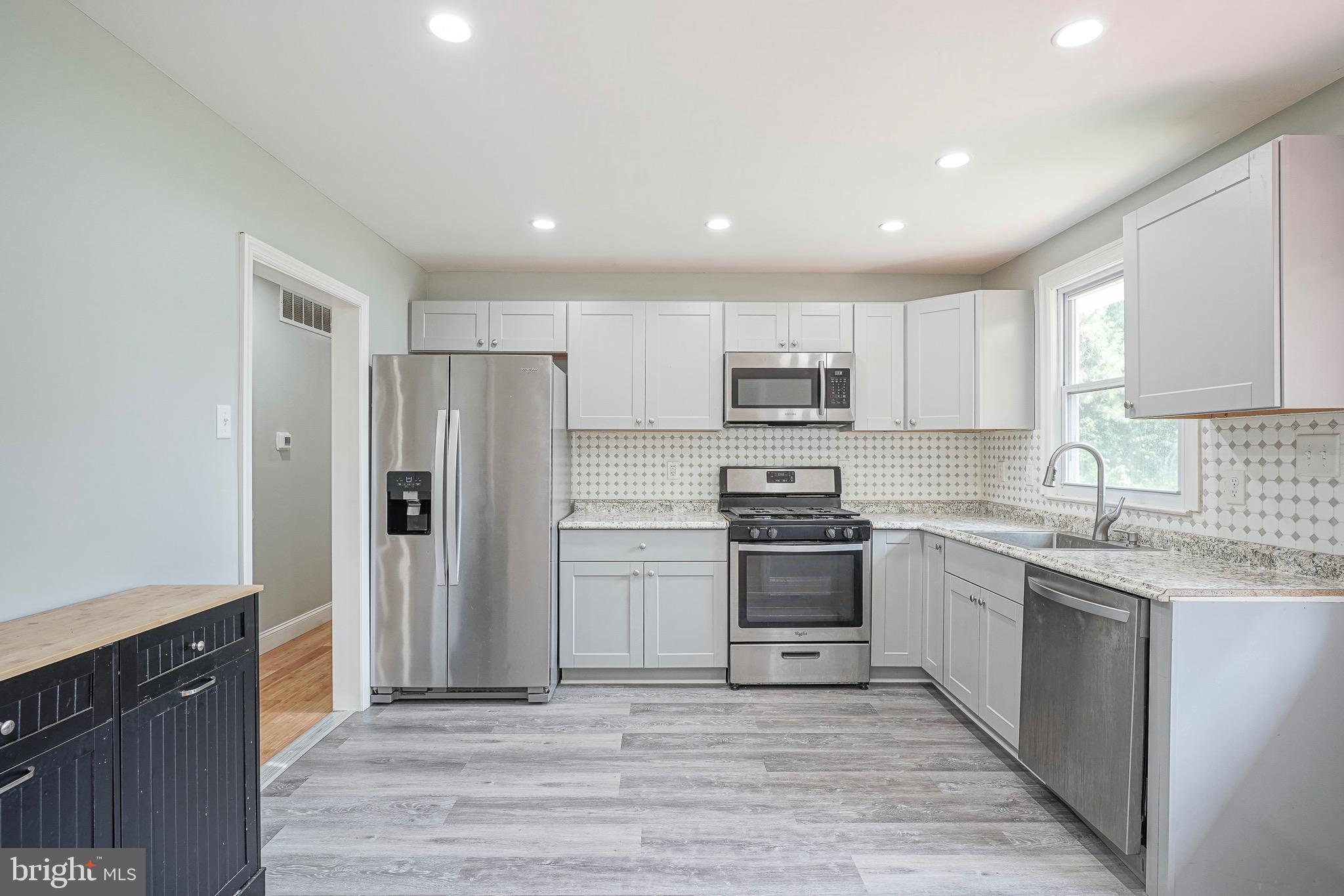 232 Egg Harbor Road Sewell, NJ 08080 - Photo 14 of 36 a kitchen with stainless steel appliances granite countertop a refrigerator and a stove top oven