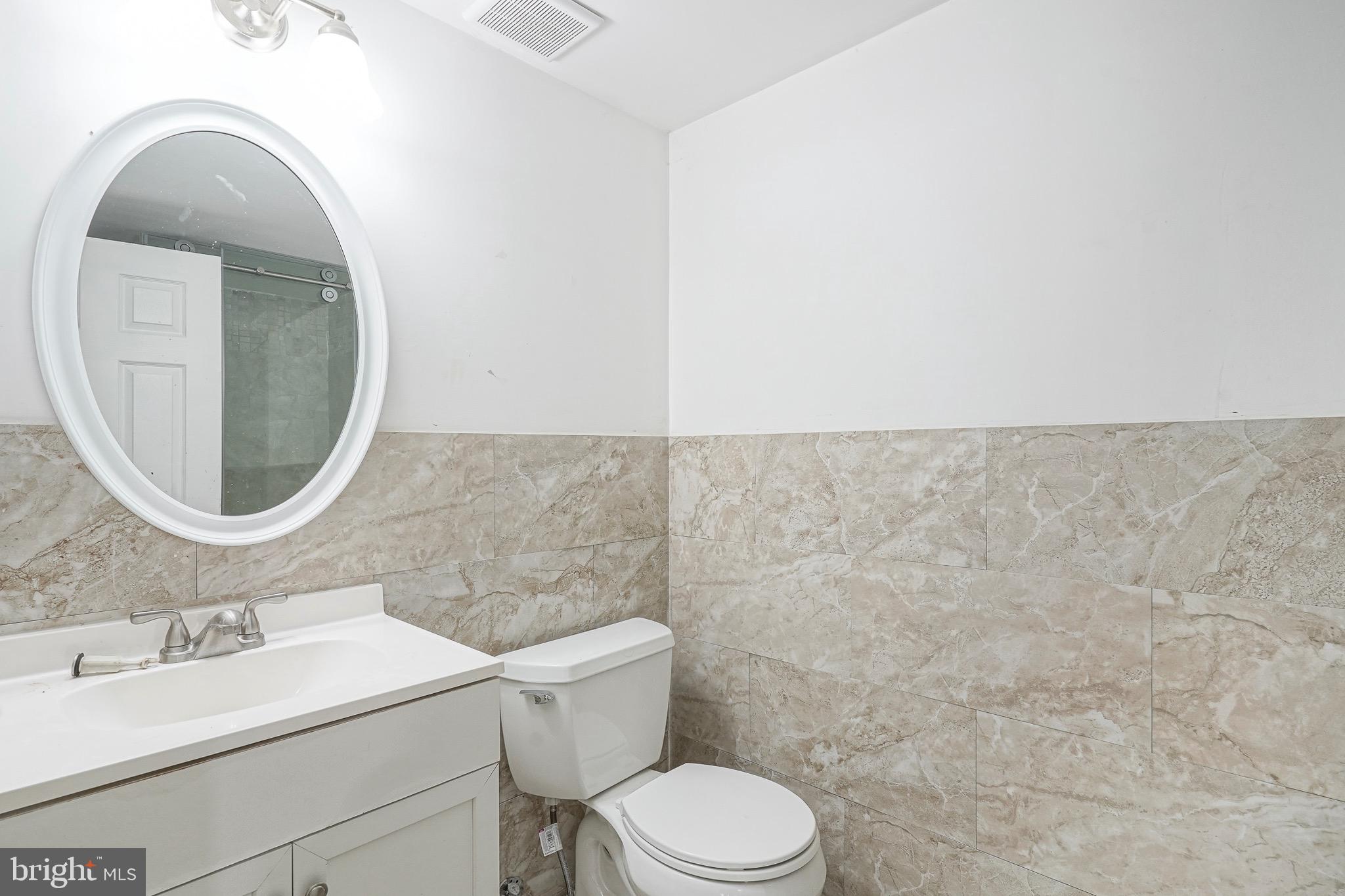 232 Egg Harbor Road Sewell, NJ 08080 - Photo 18 of 36 a bathroom with a toilet sink vanity and mirror