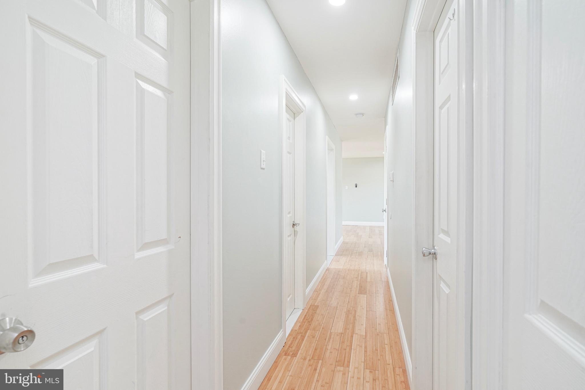 232 Egg Harbor Road Sewell, NJ 08080 - Photo 26 of 36 a view of a hallway with wooden floor and a bathroom