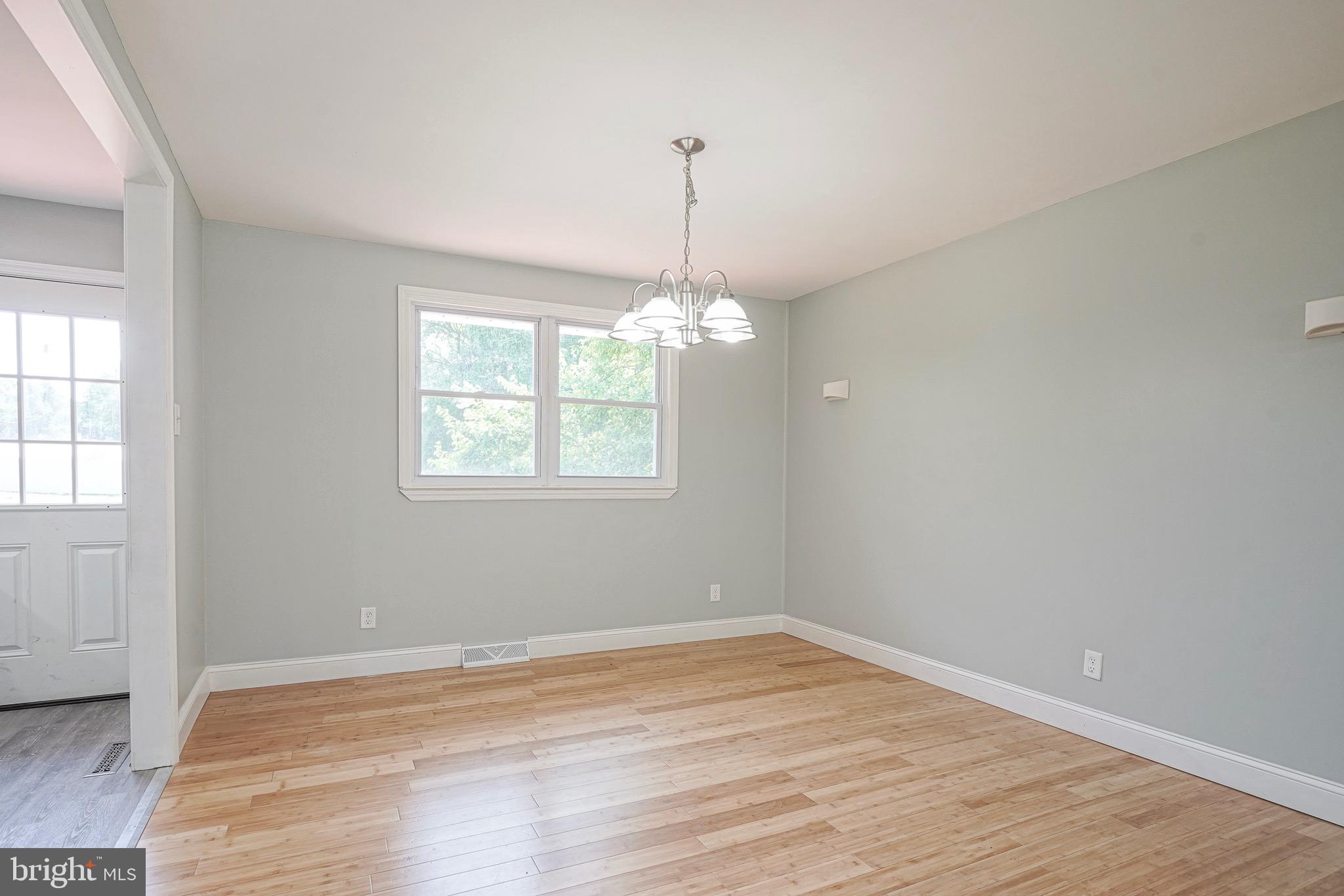 232 Egg Harbor Road Sewell, NJ 08080 - Photo 5 of 36 an empty room with wooden floor chandelier and windows