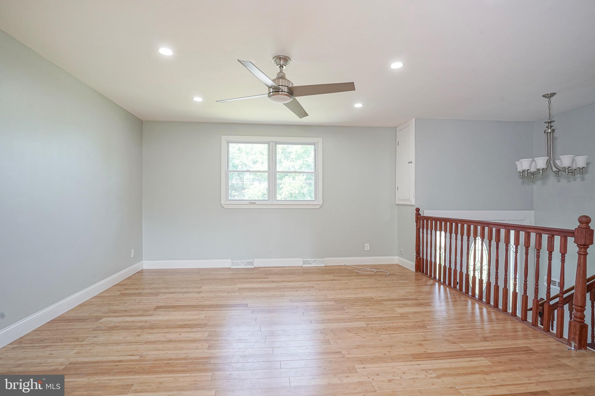 232 Egg Harbor Road Sewell, NJ 08080 - Photo 10 of 36 an empty room with wooden floor fan and windows