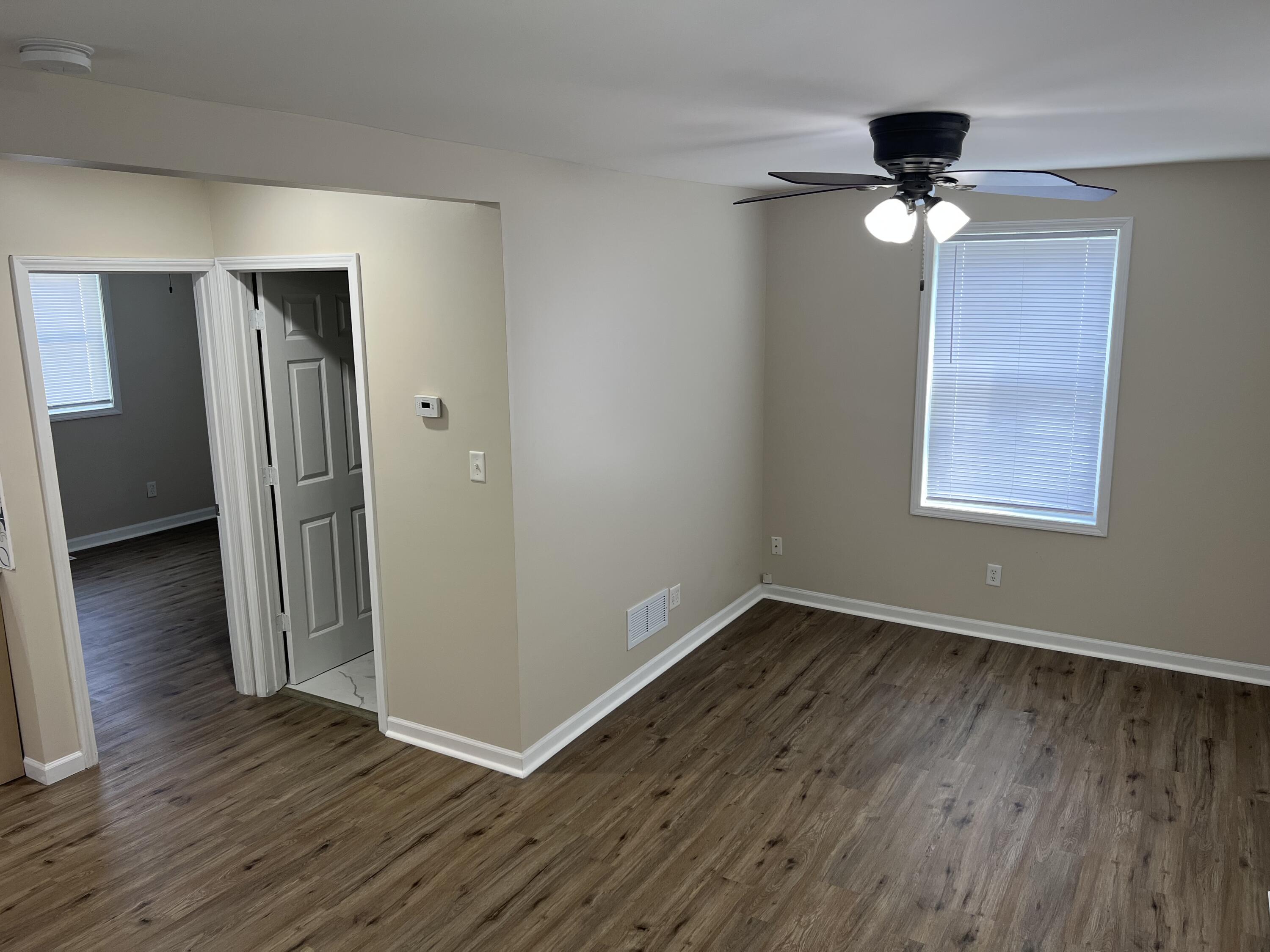 3851 Maple Street Hobart, IN 46342 - Photo 9 of 28 a view of an empty room with wooden floor and a window
