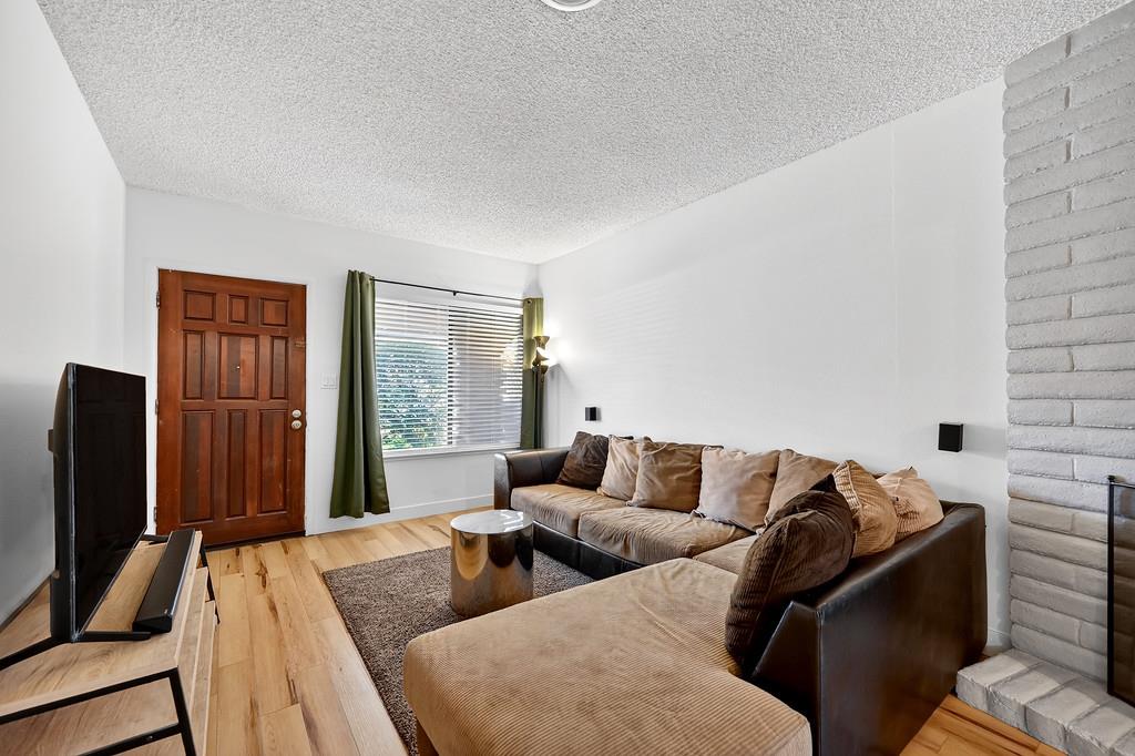 1052 Clinton Road Sacramento, CA 95825 - Photo 11 of 52 a living room with furniture rug and a flat screen tv
